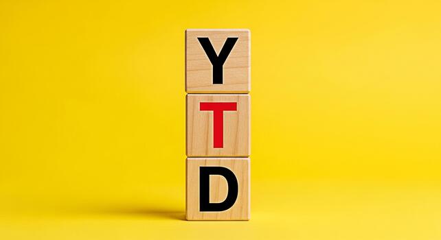 Wooden blocks displaying YTD on a vibrant yellow background representing financial performance and tracking progress towards yearly goals with a focus on business analytics and investment strategies photo