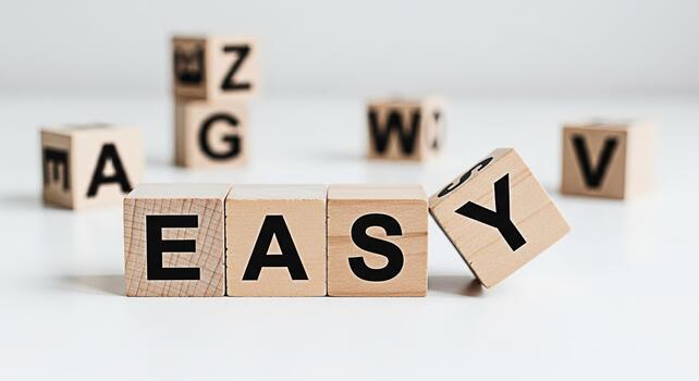Wooden blocks spelling EASY on a white surface conveying simplicity and straightforwardness ideal for educational materials business solutions and promoting a userfriendly approach in a clean and mini photo