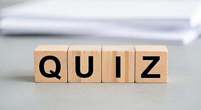 Wooden blocks spelling QUIZ on a gray surface inviting participation in a fun and engaging knowledge test promoting learning and intellectual stimulation in an educational setting photo