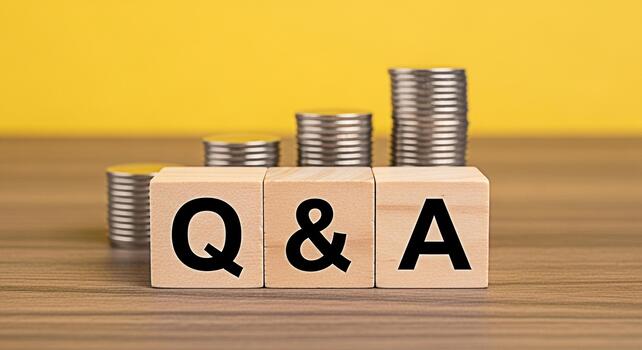 Wooden blocks displaying Q A sit in front of stacks of coins representing financial questions and answers set against a bright yellow background symbolizing clarity and knowledge in financial matters photo