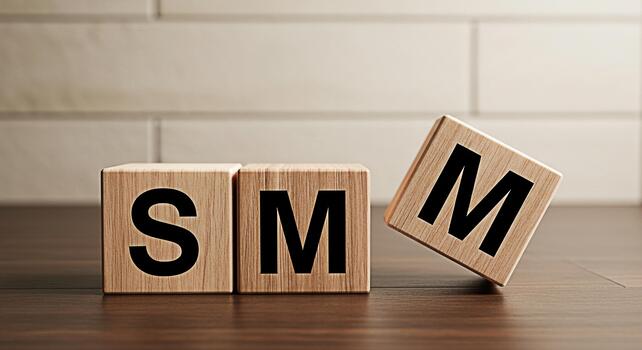 Wooden blocks spelling out SM on a dark wood surface with one block slightly tilted conveying a message of social media marketing and brand strategy in a modern minimalist setting photo