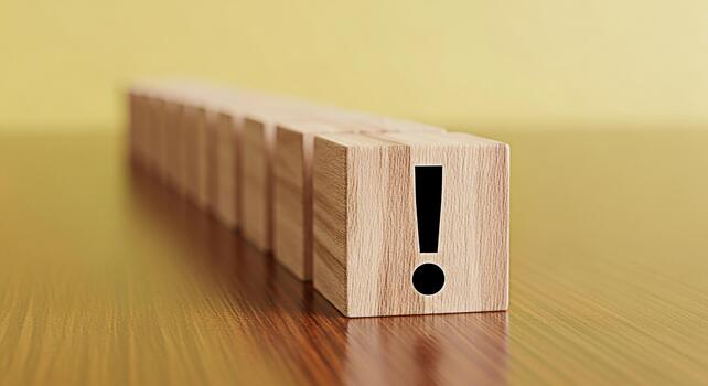 Wooden blocks displaying an exclamation mark in a row on a wooden table symbolizing urgency and attention to detail in a business or educational setting creating a sense of importance and focus photo