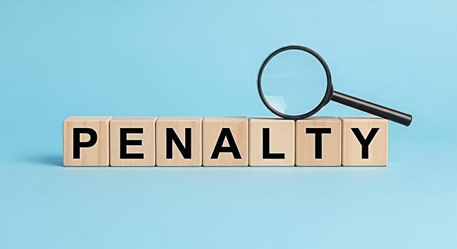 Magnifying glass inspecting the word PENALTY spelled out with wooden blocks on a light blue background symbolizing scrutiny and potential consequences creating a serious and investigative mood photo