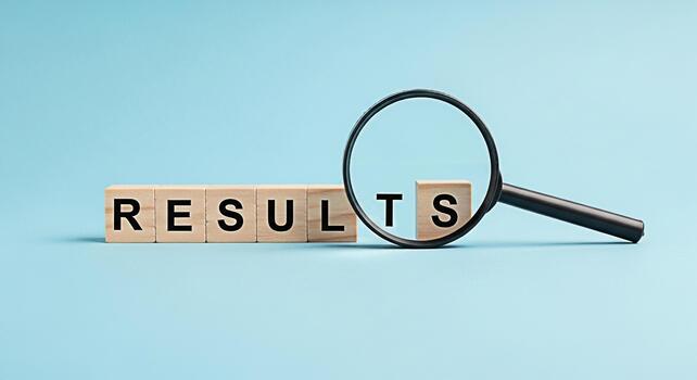 Magnifying glass inspecting wooden blocks spelling RESULTS on a light blue background symbolizing data analysis performance evaluation and the importance of achieving positive outcomes in business and photo