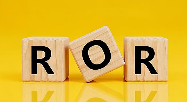 Wooden blocks spelling ROR resting on a bright yellow surface symbolizing Ruby on Rails development conveying a modern clean and minimalist aesthetic for software and web development concepts photo