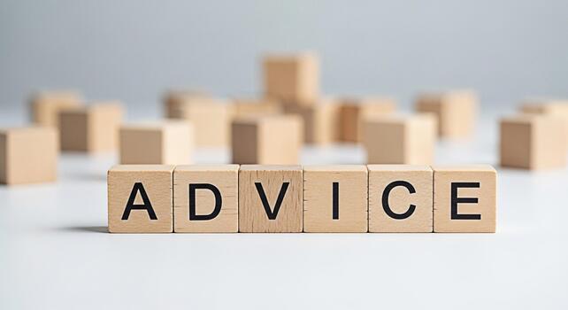 Wooden blocks spelling ADVICE on a white surface offering guidance and support in a clean minimalist setting conveying a message of wisdom and helpfulness for business and personal growth photo