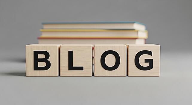 Wooden blocks spelling BLOG with books stacked in the background on a gray surface representing online content creation and knowledge sharing in a simple and minimalist style photo