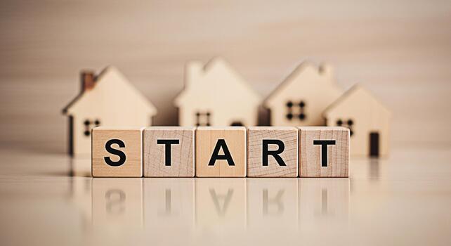 Wooden blocks spelling START in front of miniature house models on a reflective surface symbolizing new beginnings homeownership and the excitement of starting a new chapter in life photo