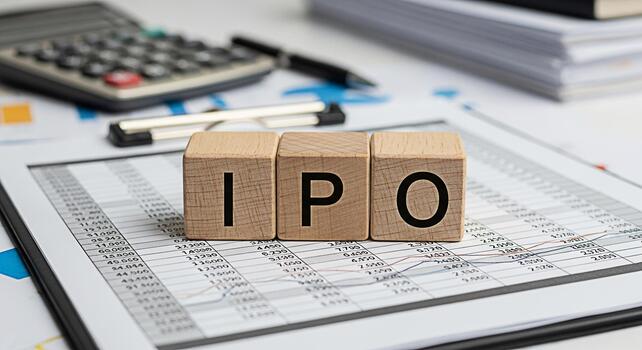 Wooden blocks spelling IPO resting on financial data sheets in a bright office setting symbolizing the concept of Initial Public Offering and investment opportunities for business growth and success photo