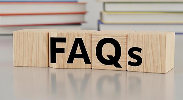 Wooden blocks spelling FAQs on a reflective surface in a bright studio setting representing information access and customer support with a focus on clarity and helpfulness for online resources photo