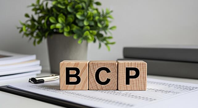 Wooden blocks spelling BCP on a clipboard in a bright office setting representing Business Continuity Planning risk management and disaster recovery with a focus on preparedness and resilience photo