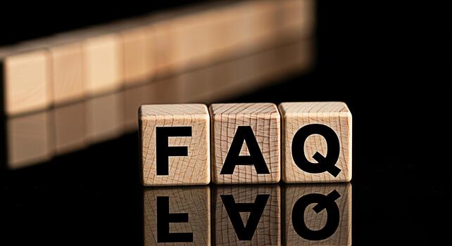 Wooden blocks spelling FAQ on a reflective black surface representing frequently asked questions and information conveying clarity and guidance in a simple and direct manner photo