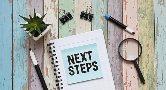 Notepad displaying Next Steps on a rustic wooden desk surrounded by office supplies symbolizing planning and forwardthinking in a creative and organized workspace fostering a sense of motivation and p photo