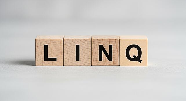 Wooden blocks spelling LINQ on a gray surface representing a programming concept in a clean minimalist setting conveying precision and focus in software development and data querying photo