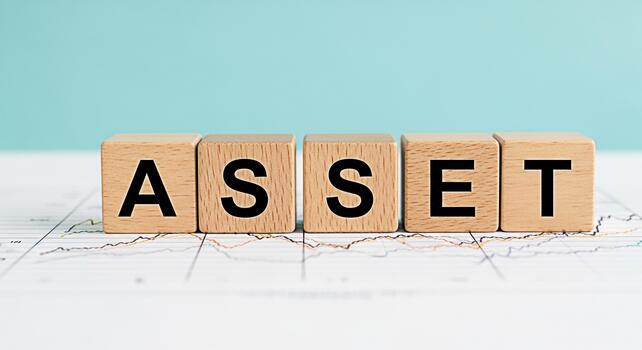 Wooden blocks spelling ASSET resting on a financial chart against a light blue background representing financial security and investment growth with a focus on building wealth and managing resources e photo