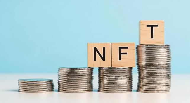 Stacks of coins displaying NFT on wooden blocks in a bright studio setting representing the growth and investment in nonfungible tokens and the potential for financial success in the digital art marke photo
