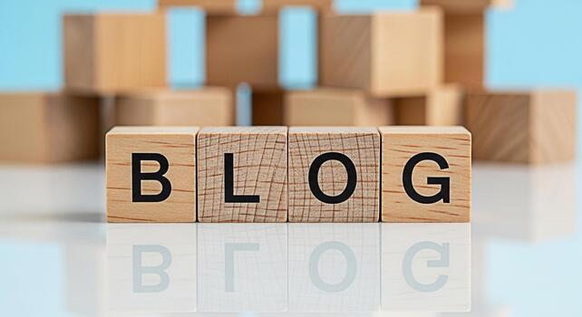 Wooden blocks spelling BLOG on a reflective surface promoting online content creation and sharing in a bright minimalist setting conveying a message of information and connection photo
