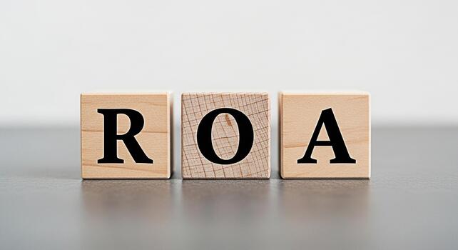 Wooden blocks displaying ROA on a gray surface representing Return on Assets a key financial metric for evaluating a companys profitability and efficiency in asset utilization conveying a sense of fin photo