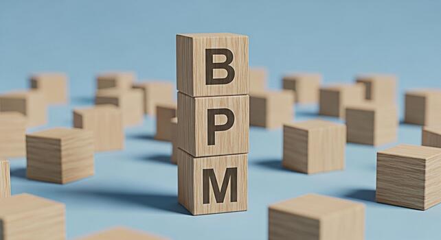 Wooden blocks spelling BPM standing tall amidst scattered blocks on a blue surface symbolizing business process management and efficiency in a clean minimalist setting conveying a sense of organizatio photo