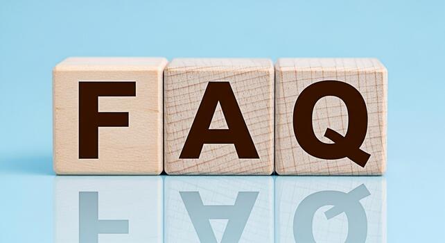 Wooden blocks displaying FAQ on a reflective surface against a light blue backdrop representing frequently asked questions and providing helpful information with a clean and modern aesthetic photo
