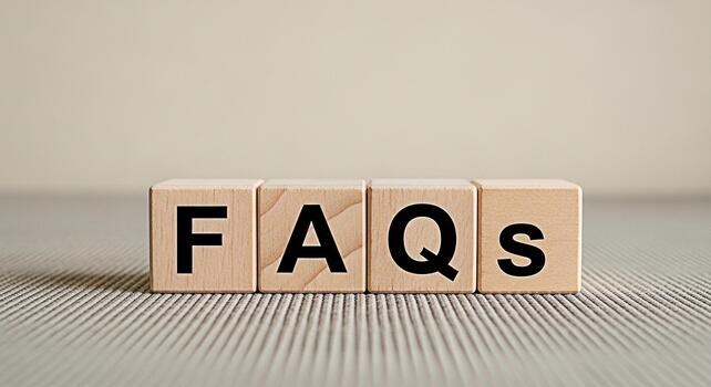 Wooden blocks displaying FAQs on a textured surface representing information access and customer support in a simple clear and accessible manner emphasizing knowledge and problemsolving photo