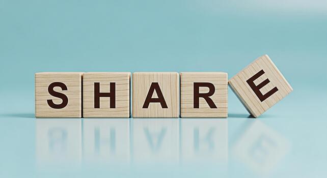 Wooden blocks spelling the word SHARE on a light blue surface promoting community and connection symbolizing generosity and collaboration in a bright and optimistic setting fostering a sense of unity photo