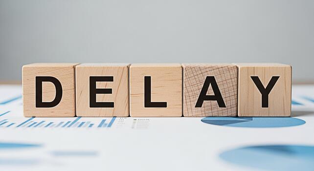 Wooden blocks spelling DELAY on a financial report symbolizing project delays and potential setbacks in business planning and execution creating a sense of urgency and the need for proactive problemso photo