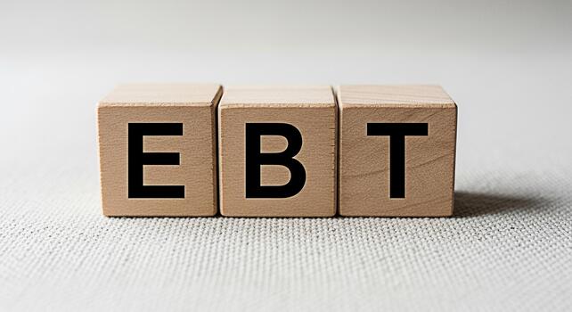 Wooden blocks displaying EBT on a textured surface representing government assistance and food security symbolizing support and resources for families in need promoting awareness and understanding photo