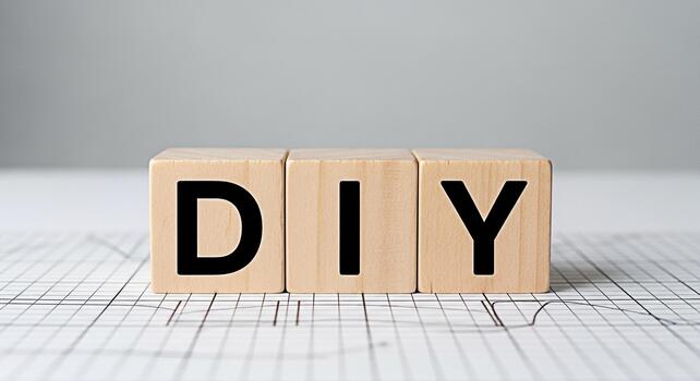 Wooden blocks spelling DIY on a graph paper surface representing a creative and handson approach to projects and crafts in a bright and inspiring studio environment encouraging innovation and selfsuff photo