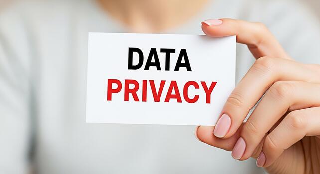 Closeup of a womans hand holding a card with the words Data Privacy in a bright neutral setting emphasizing the importance of digital security and personal information protection photo