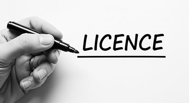 Hand underlining the word LICENCE on a white surface with a black marker emphasizing the importance of authorization and compliance in a clear and concise manner promoting legality and regulation photo