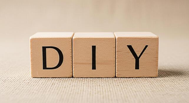 Wooden blocks spelling DIY on a burlap surface representing creativity and crafting suggesting a sense of accomplishment and the joy of making something with your own hands in a cozy setting photo