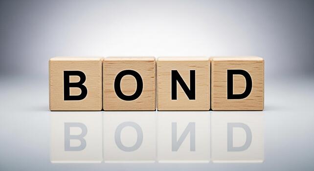 Wooden blocks spelling BOND on a reflective surface symbolizing connection and security in a financial or personal context set against a clean minimalist background conveying trust and stability photo