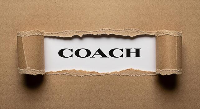 The word COACH revealed through a torn brown paper background symbolizing guidance and support creating a sense of discovery and unveiling potential with a motivational and empowering mood photo