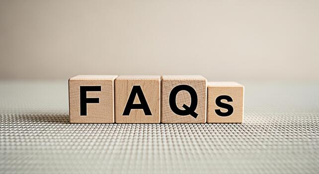 Wooden blocks displaying FAQs on a textured surface representing frequently asked questions in a simple and informative way ideal for websites presentations and educational materials conveying clarity photo