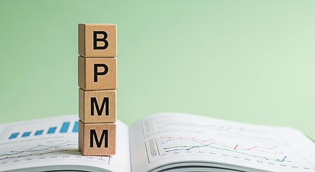Wooden blocks spelling BPM on a financial report in a bright studio representing Business Process Management and its importance in datadriven decisionmaking for improved efficiency and strategic plann photo