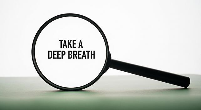 Magnifying glass focusing on the phrase Take a deep breath in a serene studio setting promoting mindfulness and stress reduction through a simple calming message encouraging relaxation and wellbeing photo