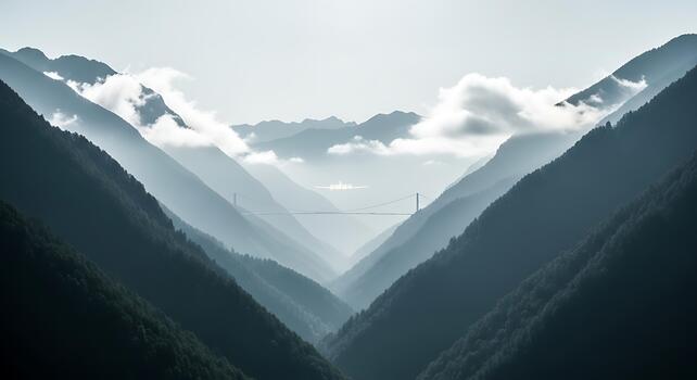 A breathtaking view of a mountain range with fog and clouds rolling through the valleys photo