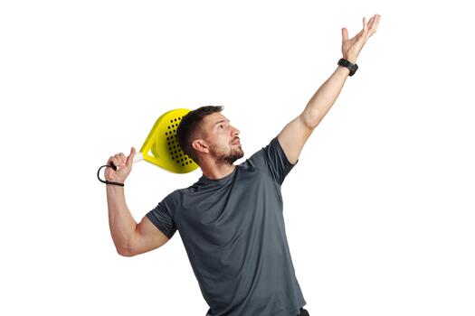 Man practicing a serve using a bright yellow paddle in an indoor setting photo