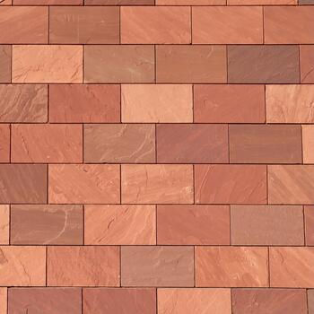 Abstract full frame closeup of a wall of brown, terracotta-colored, and reddish rectangular bricks, showcasing their varied textures and hues in a precise, geometric pattern. photo