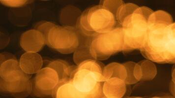 Bokeh glitter abstract golden light background creating vibrant warm motion effect on dark water surface. video