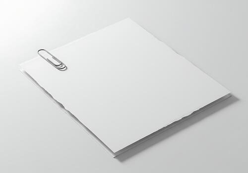 Minimalist composition featuring blank white paper sheets fastened with a metal paperclip on a bright, uncluttered background for various design photo