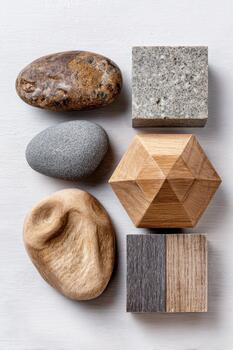 geométrico Roca y de madera formas arreglado artísticamente en un ligero fondo, exhibiendo natural texturas y formularios, ideal para conceptual diseño y visual cuentacuentos foto