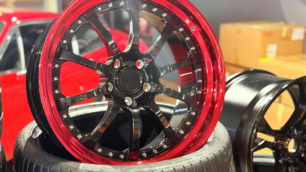 Modern alloy car wheels in red and black color combination automotive tuning and customization concept of performance design and style photo