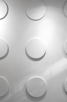 Circular patterns create a unique texture on a modern wall in a bright interior space photo
