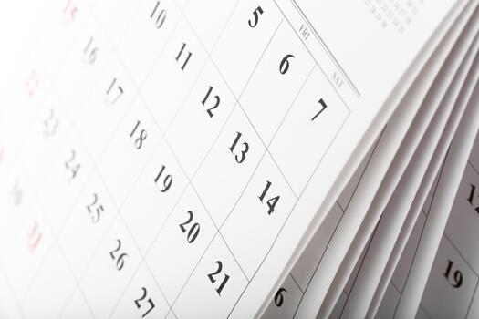 Close view of a flipped calendar page showing dates and days of the week in a minimal design photo