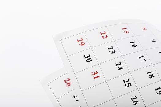 Calendar page showing dates in red and black indicating the end of the month in a simple layout photo