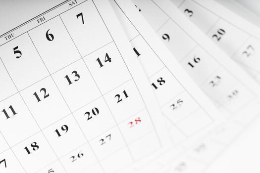 Calendar pages turning with visible dates marked and highlighted in red photo