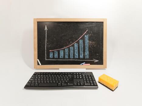 a keyboard, mouse and a chalkboard with a graph on it photo