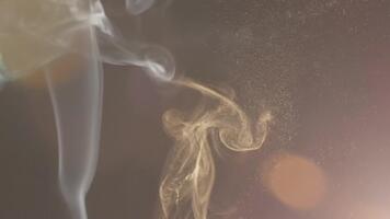 Ethereal smoke and shimmering gold dust swirling gently creating a dreamy abstract background, perfect for creative projects and elegant designs video